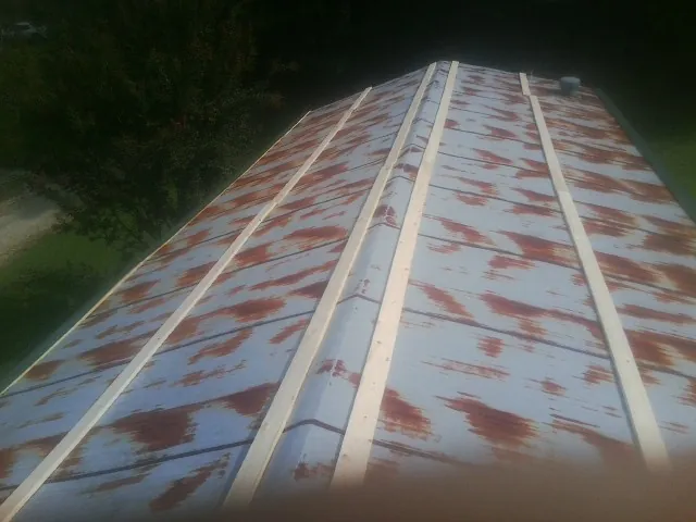 Rusted metal roof panels with new wood purlins before replacement — Storm Damage Roof Repair in Ottawa Lake by Roofing Brothers